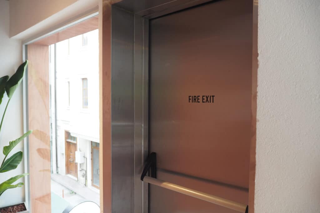 A photo of an emergency fire exit door leading out of a building.