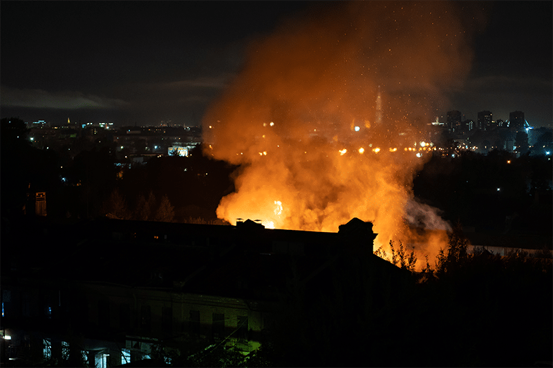 Smoke rising from a building at night